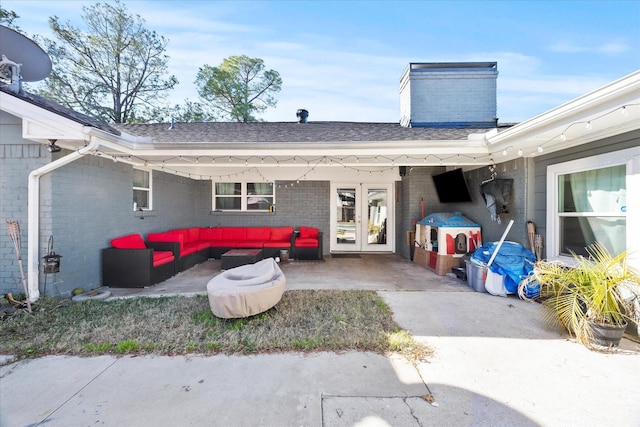 back of property with french doors, an outdoor living space, and a patio