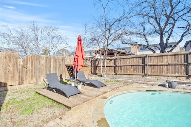 view of swimming pool with a wooden deck