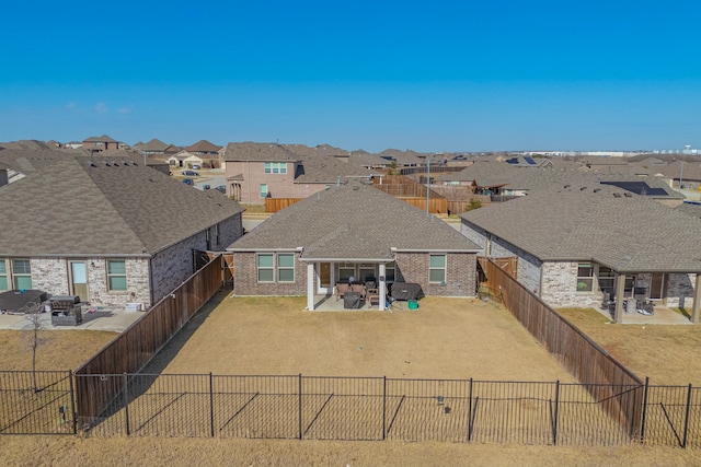 back of property featuring a patio area and a lawn