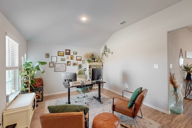 office featuring vaulted ceiling and light wood-type flooring