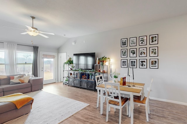 living room with vaulted ceiling, ceiling fan, and light hardwood / wood-style floors