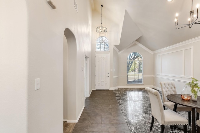 entrance foyer with vaulted ceiling and a chandelier