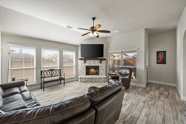 living room with baseboards, plenty of natural light, light wood finished floors, and ceiling fan
