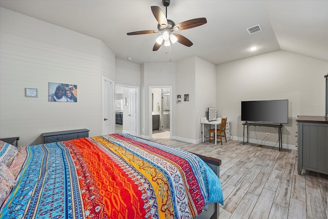 bedroom with light wood-type flooring, ceiling fan, ensuite bathroom, and lofted ceiling