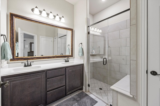 bathroom with an enclosed shower, vanity, and tile patterned floors