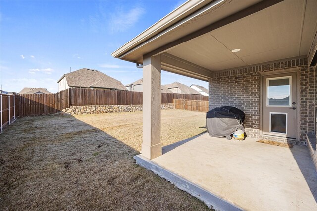 back of property with brick siding, a fenced backyard, central AC, and a yard