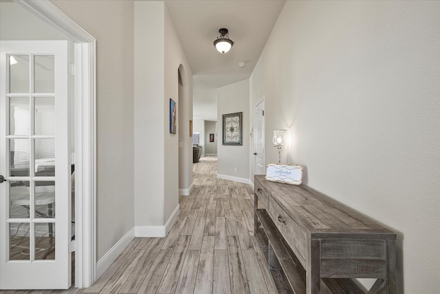 corridor with light hardwood / wood-style floors