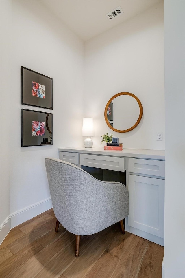 office area with built in desk and light wood-type flooring