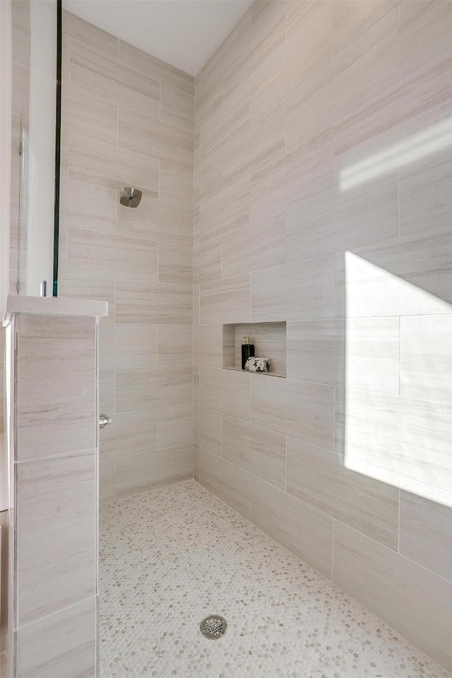 bathroom with tiled shower