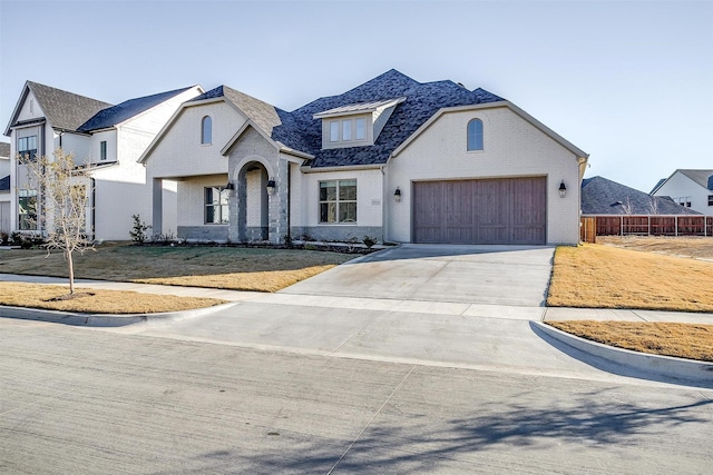 french country style house with a garage