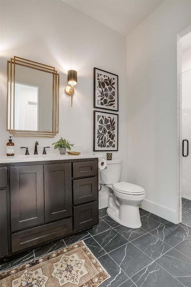 bathroom with an enclosed shower, vanity, and toilet