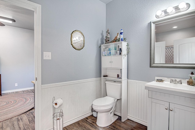 12642 Kollmeyer Way, Fort Worth, TX 76126 - full bathroom with wood finished floors, vanity, toilet, a wainscoted wall, and a ceiling fan