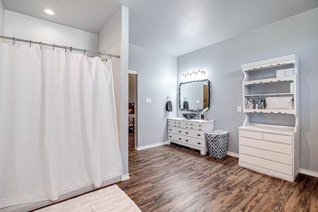 bathroom with a shower with curtain, wood-type flooring, and vanity