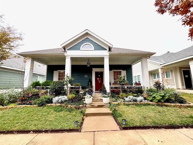 view of front of home featuring a porch and a front yard