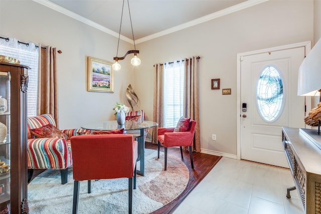 dining room featuring baseboards and crown molding