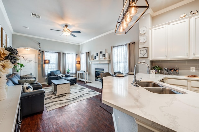 kitchen with white cabinetry, visible vents, pendant lighting, and open floor plan