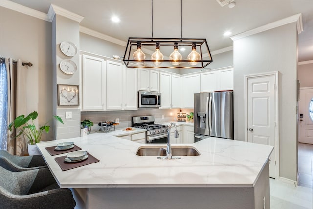 kitchen featuring appliances with stainless steel finishes, a sink, a peninsula, and light stone countertops