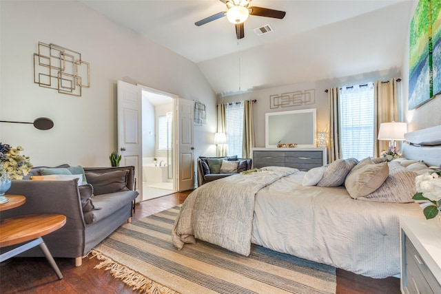 bedroom featuring lofted ceiling, ceiling fan, wood finished floors, visible vents, and ensuite bath