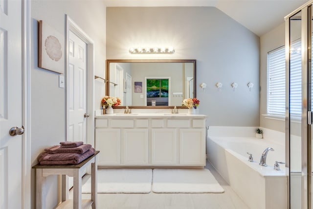 full bathroom featuring lofted ceiling, a sink, double vanity, and a bath