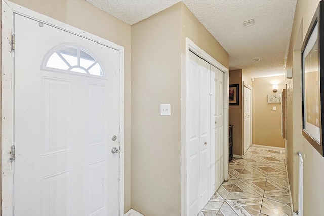 foyer featuring a textured ceiling