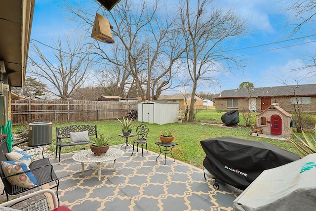 view of patio with central air condition unit and a shed