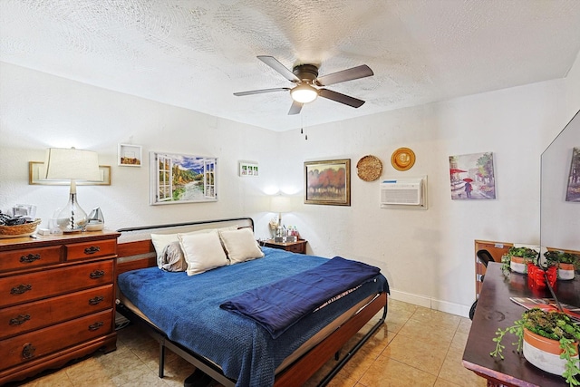 bedroom featuring a textured ceiling, ceiling fan, light tile patterned floors, and an AC wall unit