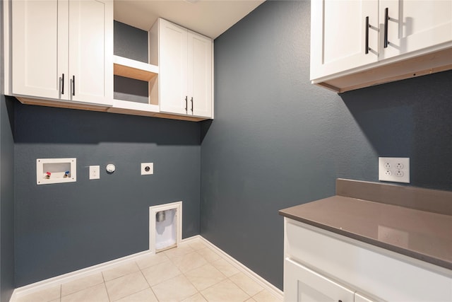 laundry room with baseboards, cabinet space, electric dryer hookup, washer hookup, and tile patterned flooring