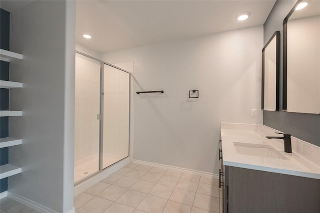 bathroom featuring tile patterned floors, a stall shower, recessed lighting, baseboards, and vanity