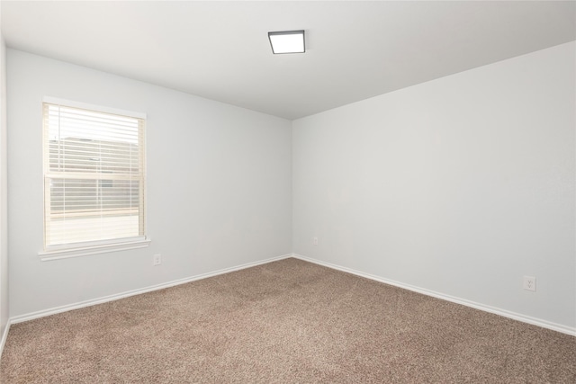 carpeted spare room with baseboards