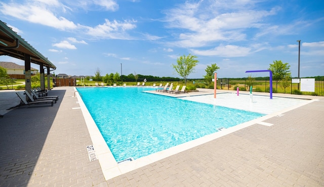 pool with fence and a patio area