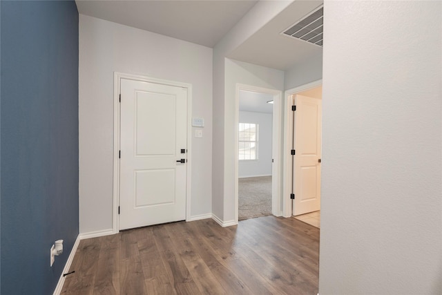 entrance foyer with visible vents, baseboards, and wood finished floors