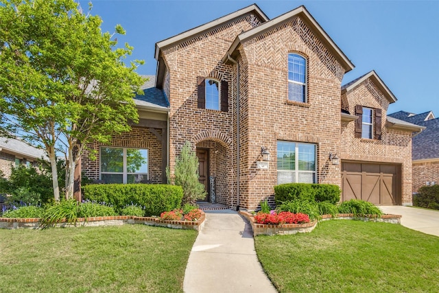 view of front of property featuring a garage and a front lawn