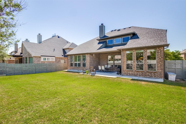 back of property featuring a patio and a yard