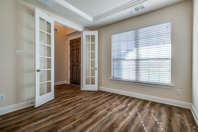 spare room featuring french doors, dark wood-type flooring, and ornamental molding