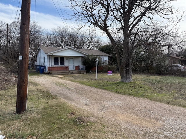 view of front of home with a front yard and a porch