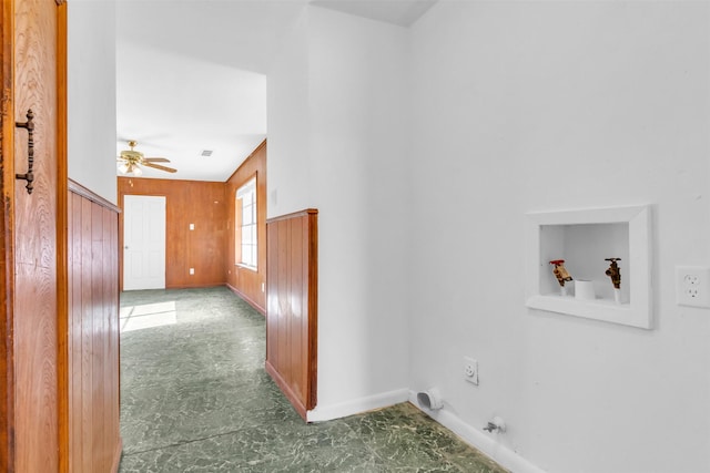 washroom featuring ceiling fan, hookup for an electric dryer, wooden walls, and hookup for a washing machine