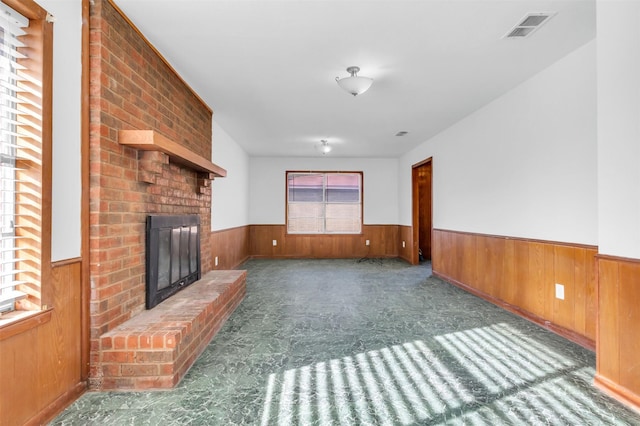 unfurnished living room featuring a brick fireplace