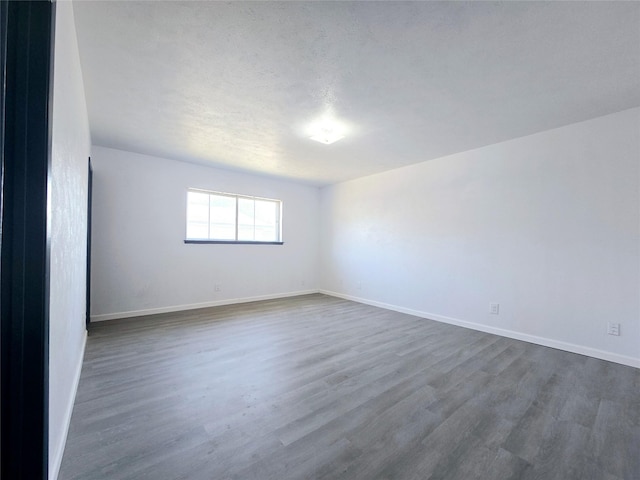 unfurnished room featuring dark hardwood / wood-style flooring