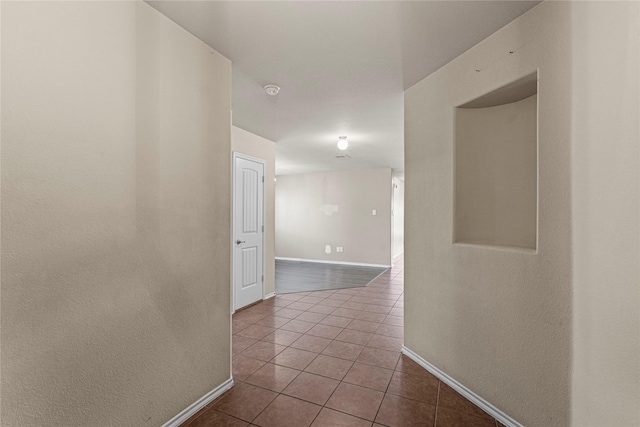 hallway with tile patterned flooring