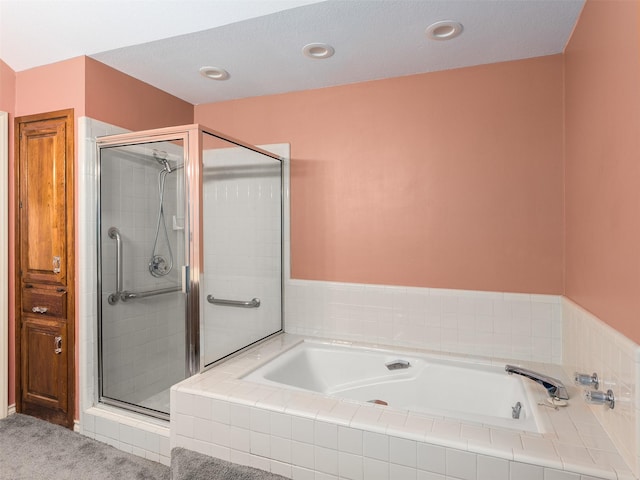 bathroom featuring separate shower and tub