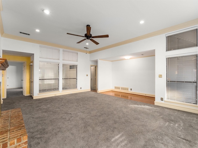 unfurnished living room with ceiling fan, dark carpet, and ornamental molding