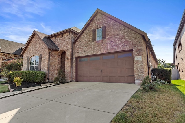 view of front of property with a garage and a front yard