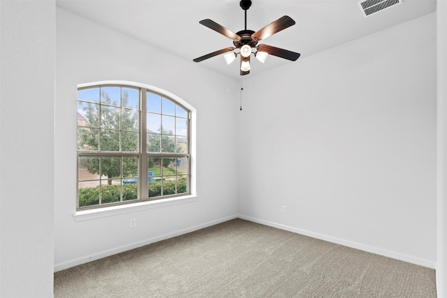 carpeted empty room featuring ceiling fan