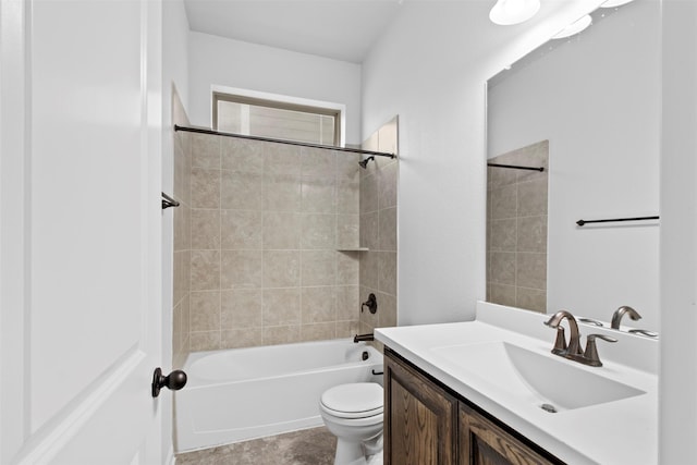 full bathroom featuring tiled shower / bath combo, vanity, and toilet