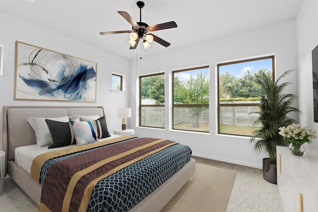 bedroom with ceiling fan and light carpet