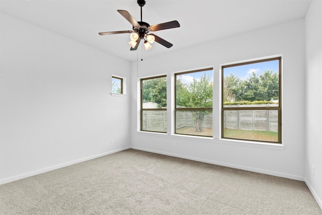 spare room featuring ceiling fan and carpet