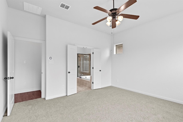 unfurnished bedroom featuring ceiling fan, connected bathroom, and light carpet