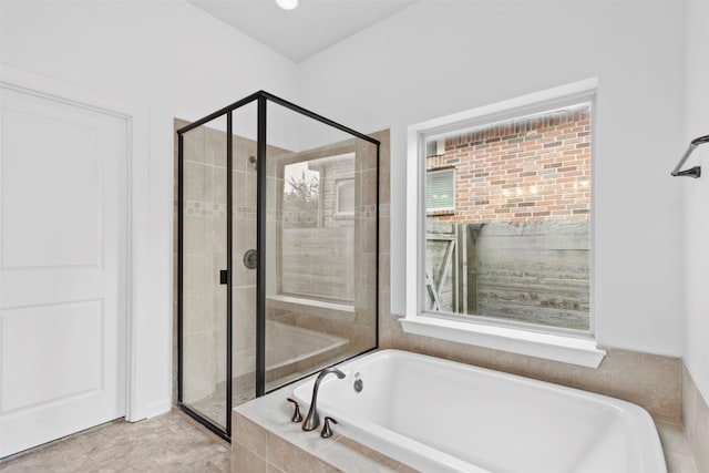 bathroom with shower with separate bathtub