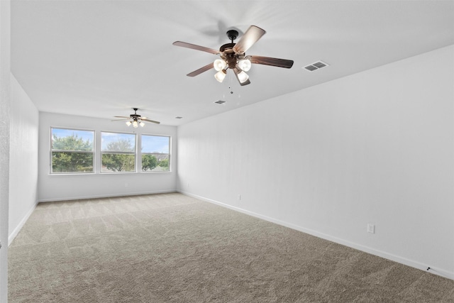 unfurnished room featuring light carpet and ceiling fan