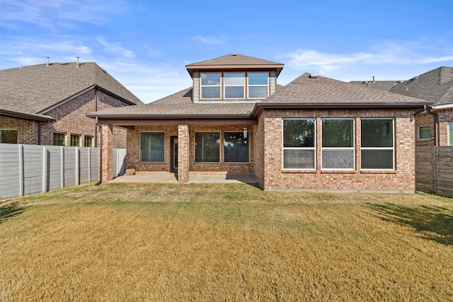 back of house featuring a patio area and a yard